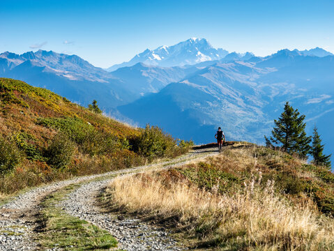 Man walking in front of mountains on sunny day at Vanoise national park, France