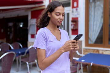 Young african american woman smiling confident using smartphone at coffee shop terrace