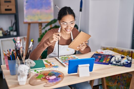Young african american woman artist having online draw class at art studio