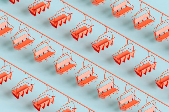 Three dimensional pattern of red ski lifts floating against blue background