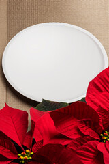 Christmas poinsettia with white plate placemat on gold placemat