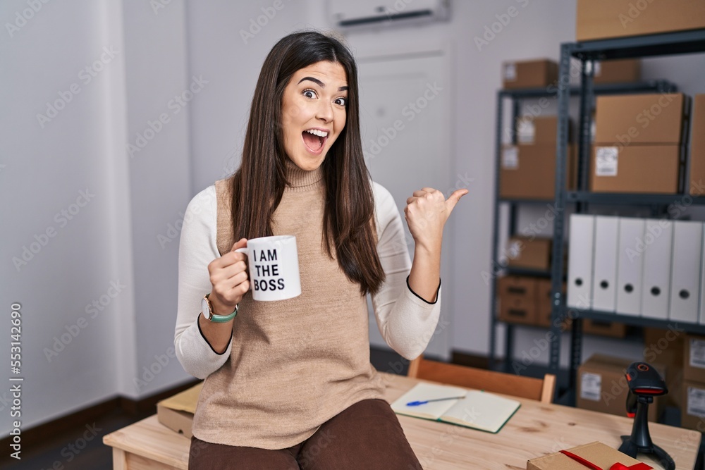 Sticker young brunette woman working at small business ecommerce holding i am the boss cup pointing thumb up