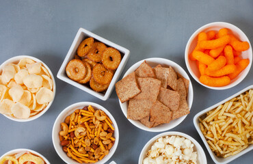 Party snacks, an assortment on gray with copy space