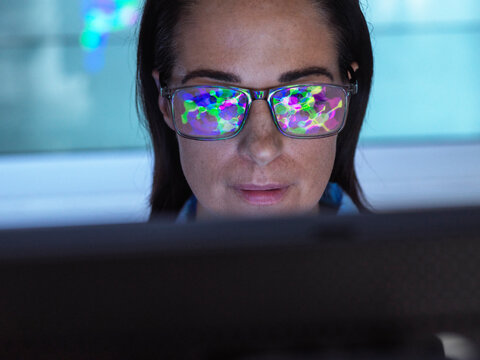 Reflection of molecular structure research on scientist's eyeglasses in laboratory