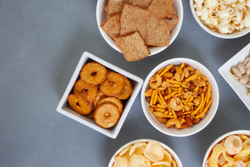 Party snacks, an assortment on gray with copy space