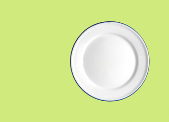 Oven safe enamelled white plate on a Lime green   background