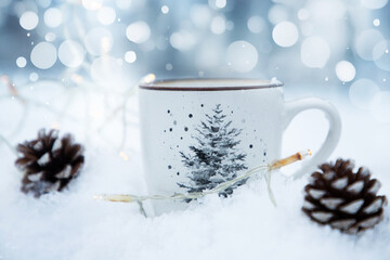 mug with hot drink in snow for Christmas