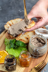 pate from duck liver with pieces of white bread on a wooden board. Gourmet appetizers, Assorted...