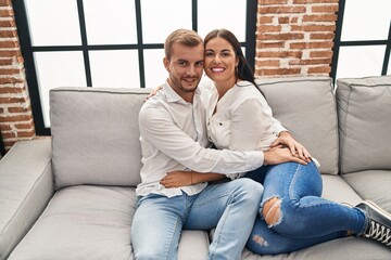 Obraz premium Man and woman couple smiling happy hugging each other at home