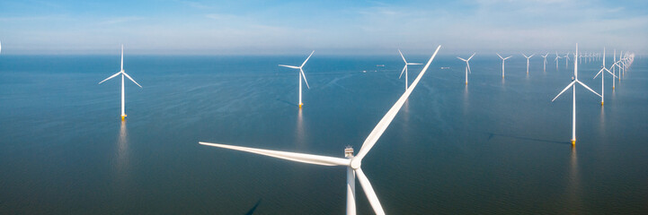 Drone Aerial view at Windmill park with windmills turbines in the ocean