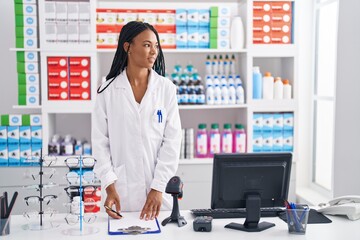 African american woman pharmacist smiling confident working at pharmacy