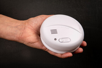 Smoke detector in a woman's hand. Security concept