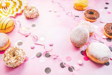 German Krapfen or donuts with streamers and confetti. Traditional Berliner for carnival and party