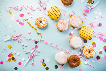 German Krapfen or donuts with streamers and confetti. Traditional Berliner for carnival and party - obrazy, fototapety, plakaty