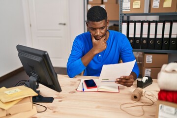 Young african american man ecommerce business worker worried reading document at office