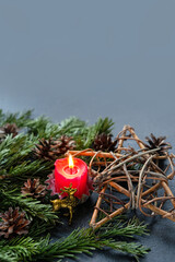 Candle, amulet with deer and pentacle star, fir branches on dark abstract background.  Witchcraft...