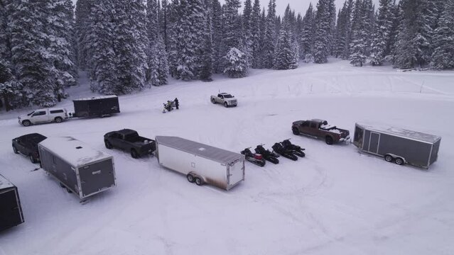 mountain parking lot drone show of snowmobiles