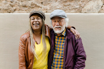 Portrait of African american senior woman and asian mature man looking at camera. Happy multiracial...