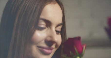 Attractive woman receives a rose and her face is delighted
