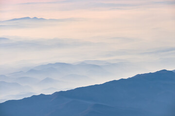 Fototapeta na wymiar Clouds And Misty Mountains, Blue Tones