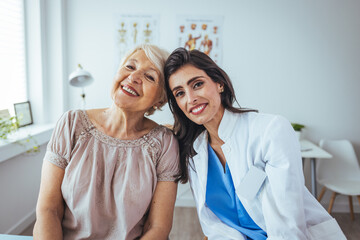 Fototapeta premium The elderly woman enjoys an embrace from her favorite home healthcare nurse. Medical care, young female doctor hugging patient. Empathy concept. Elderly woman hugging caregiver