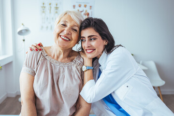 Shot of a young nurse caring for a senior woman. Portrait of optimistic old lady with caring young woman doctor, smiling happy senior mature grandmother with nurse or caregiver in hospital 
