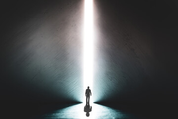 The silhouette of a man walking towards a bright light in the opened huge wall. A light in the end of a tunnel. The concept of success, freedom of choice, open mind, meditation. - 553152630
