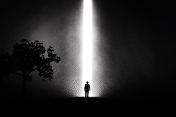 A silhouette of a man in nature next to a tree, walking towards a bright light in the opened huge wall. A light in the end of a tunnel. The concept of success, freedom, choice, open mind, meditation. - 553152654