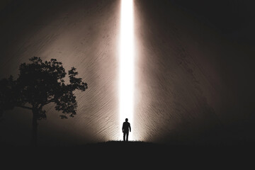 A silhouette of a man in nature next to a tree, walking towards a bright light in the opened huge wall. A light in the end of a tunnel. The concept of success, freedom, choice, open mind, meditation. - 553152665