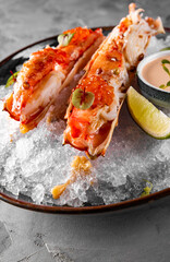 crab legs with caviar on plate with ice