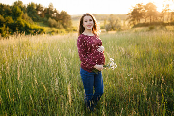 young happy beautiful couple in love walking together on grass and trees park landscape