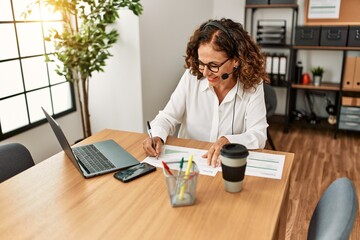 Middle age hispanic woman smiling confident working at office