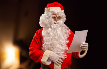Santa Claus reading a wish list