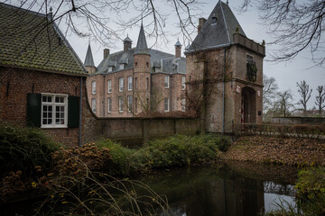 Fototapeta na wymiar The entrance to the historic building Zuylen castle or slot Zuylen as it is called in Dutch on a cold winter day. includes the bridge, keep, gate moat and main building