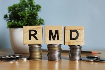 RMD concept, Required minimum distribution concept on wooden blocks.