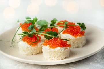 Snack with red fish on the table. Festive snack. Menu for the festive table. Side view. Copy space.