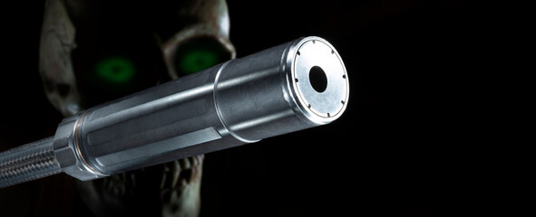 Skull with gree eyes behind a silencer