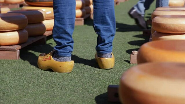 Man's Feet In Dutch Clogs At The Cheese Market In Gouda, Netherlands. closeup
