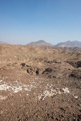Fototapeta na wymiar Vertical landscape of the beautiful Hajar Mountains of the United Arab Emirates with clear blue sky, UAE, desert landscape with copy space