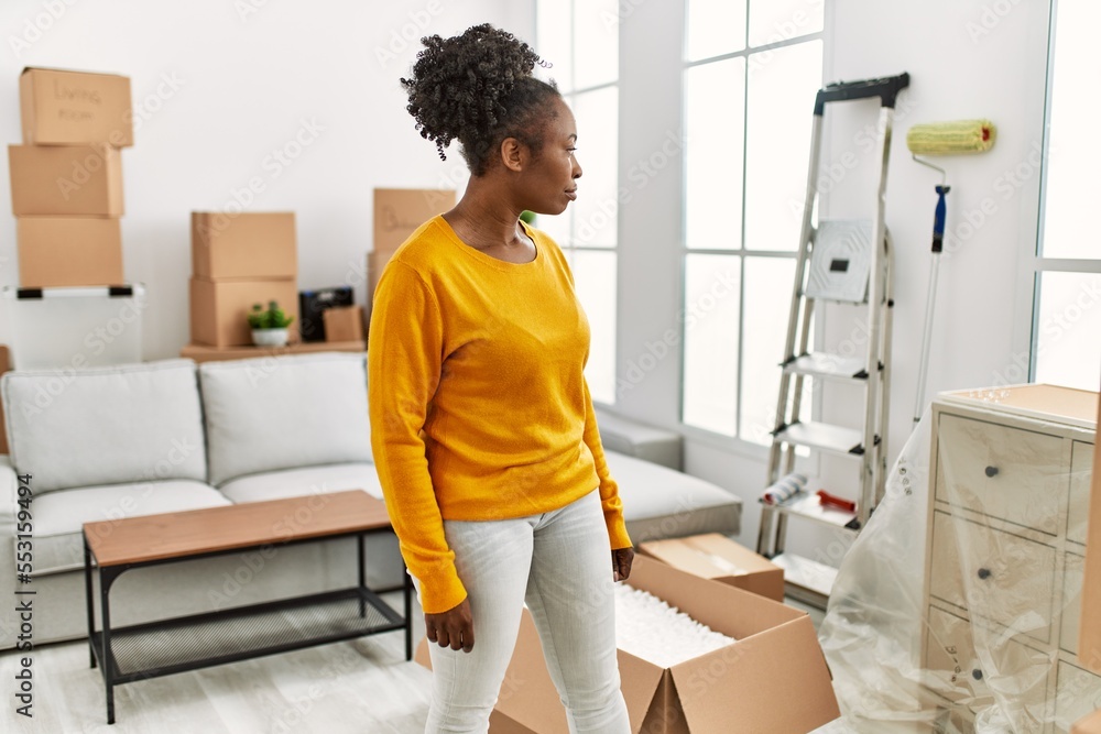 Canvas Prints African american woman standing with doubt expression at new home