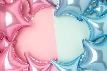 Frame made of inflatable foil balloons in a pink and blue colors. Gender reveal party concept with...