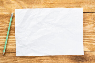 Sheet of paper lying on wooden table