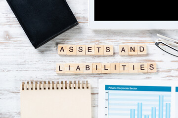 Assets and liabilities concept with letters on cubes