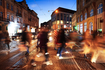 People crossing city street at night, long exposure effect © New Africa
