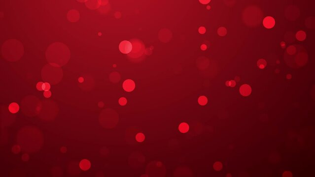 Shiny particles floating on abstract red background, bokeh particles flying slowly