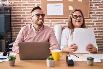 Man and woman business workers using laptop working at office