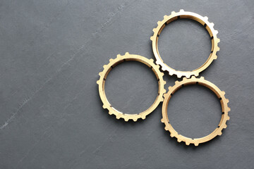 Stainless steel gears on grey background, flat lay. Space for text