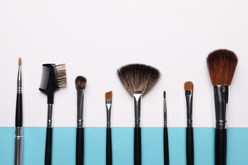 Set of makeup brushes on color background, flat lay. Space for text