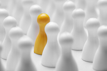 Yellow pawn among others on white background, closeup. Recruiter searching employee