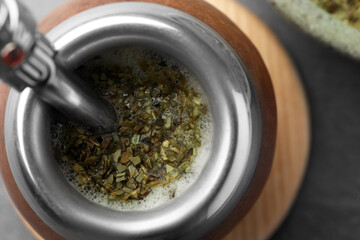 Calabash with bombilla and mate tea on table, top view
